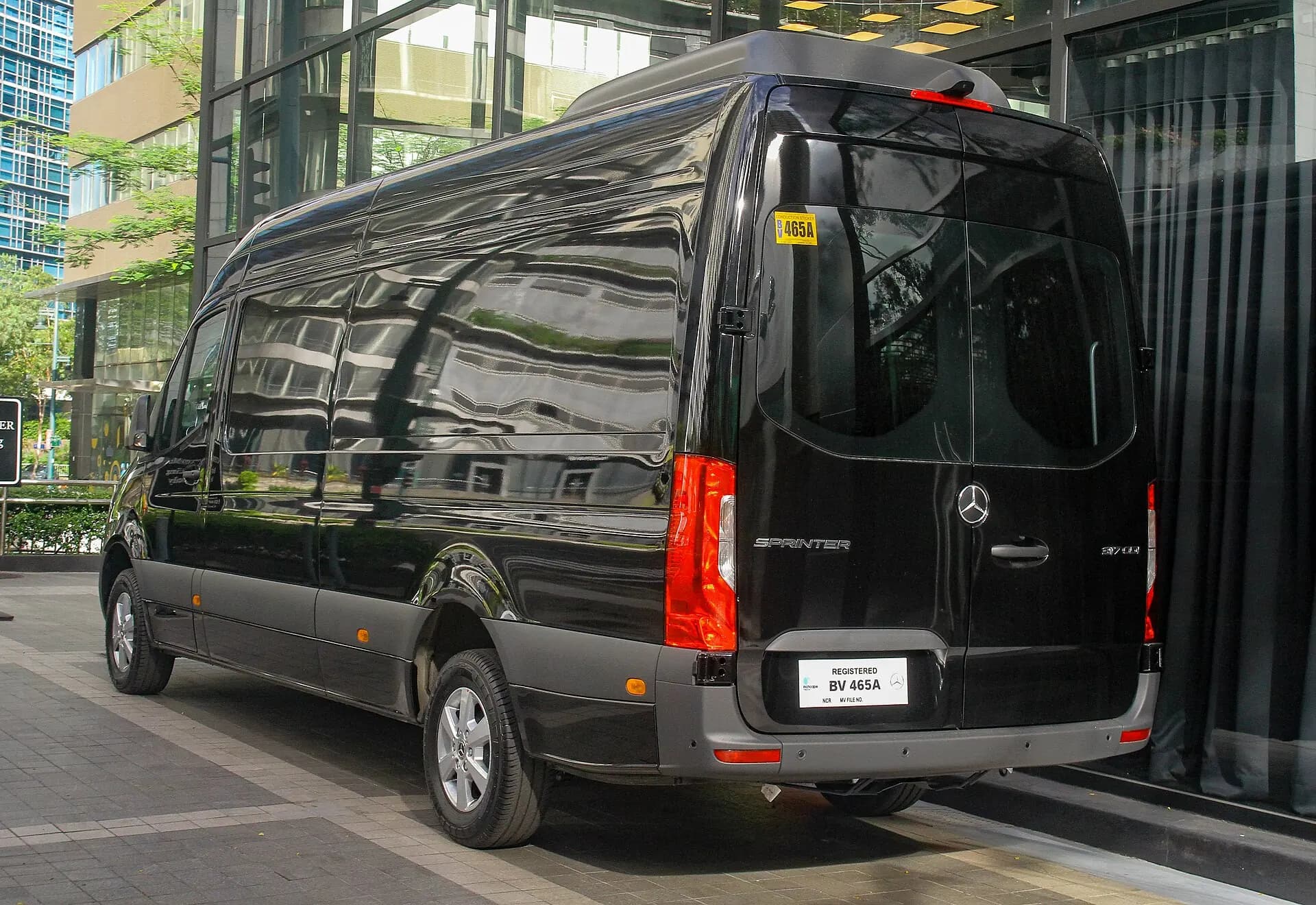 Rear view of a black Mercedes-Benz high-roof Passenger Sprinter.