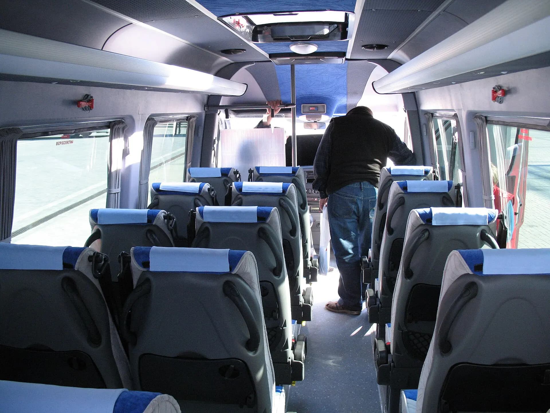 Passenger Sprinter interior with forward-facing seating rows.