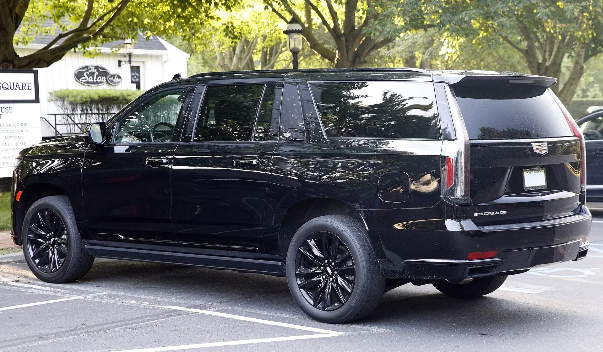 Rear three-quarter view of a black Cadillac Escalade ESV.